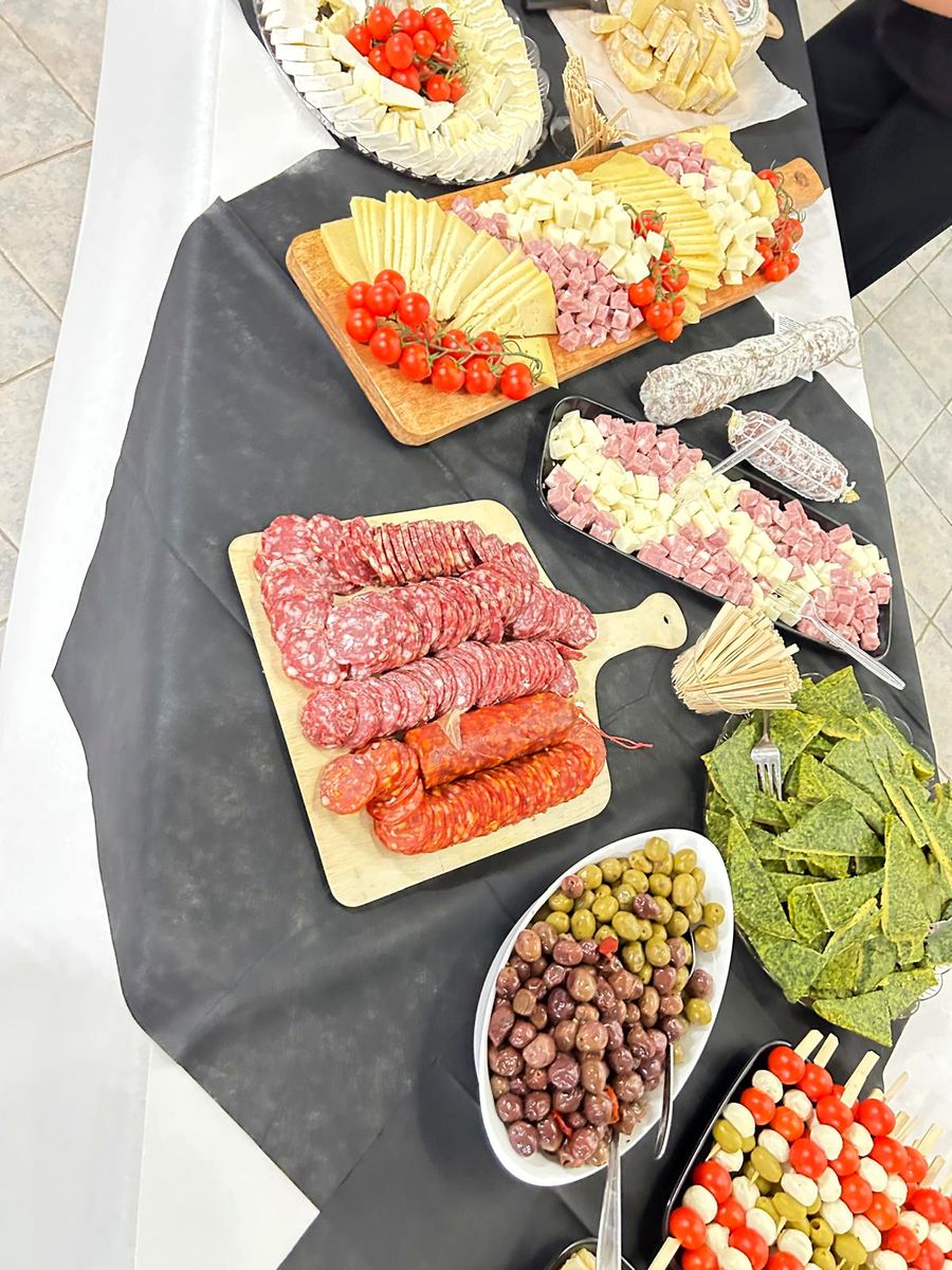 Taglieri di salumi e formaggi, olive e spiedini su un buffet